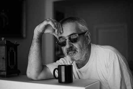 Photo for Over his morning coffee, he thinks about what awaits him. - Royalty Free Image