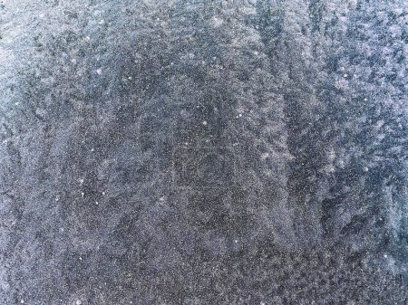 Texture of ice on the window that can be used as a handwritten background