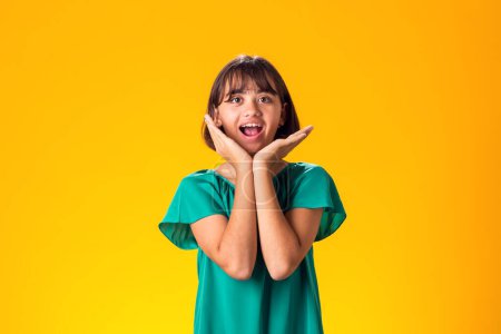 Photo for Surprised kid girl over yellow background. Astonishment emotion concept - Royalty Free Image