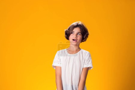 Photo for Smiling kid girl over yellow background. Emotion concept - Royalty Free Image