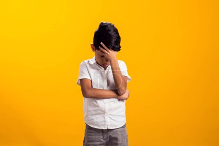 Photo for Portrait of upset kid boy over yellow background. Emotions and bulling concept - Royalty Free Image