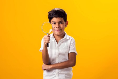 Foto de Retrato de niño sosteniendo lupa. Concepto de educación y curiosidad - Imagen libre de derechos