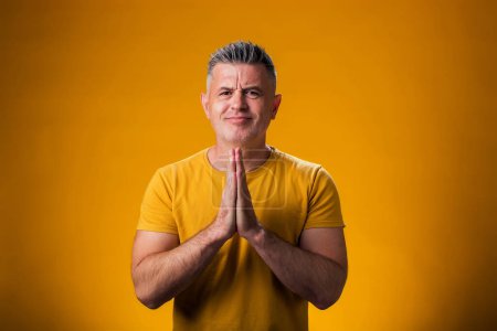 Photo for Portrait of man showing praying or hope gesture. People and emotion concept - Royalty Free Image