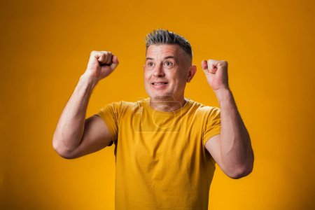 Photo for Portrait of happy man showing winner gesture with hands.  Goal achievement concept - Royalty Free Image