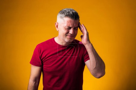Photo for Portrait of man suffering from headache desperate and stressed because pain and migraine. Hands on head. People, healthcare and medicine concept - Royalty Free Image