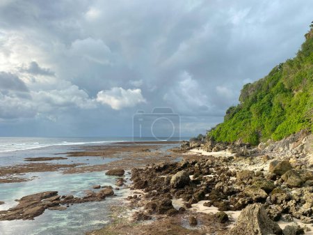 The sheer cliffs of the southern coast of Bali are washed by a clear azure ocean. Bukit Peninsula coastline. 