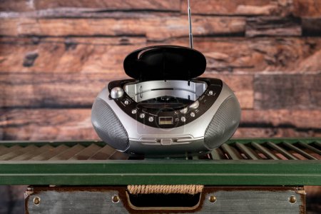 vintage radio and CD player isolated on green shutter with wood background