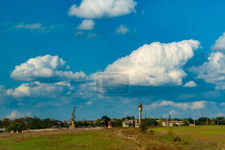 Photo for White cumulus thunderclouds in the sky over a highway, Ukraine - Royalty Free Image
