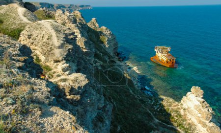Photo for The remains of a sunken ship near the coastal cliffs in the tract Dzhangul, western Crimea - Royalty Free Image