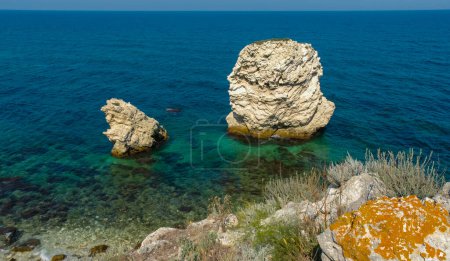Photo for Rocks and islands in the water of the Black Sea near the landslide coast of Dzhangul in the western Crimea, Tarkhankut - Royalty Free Image