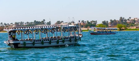 Photo for EGYPT,  LUXOR - MARCH 01, 2019: boats for walks with tourists on the Nile, Karnak, Luxor, Egypt - Royalty Free Image