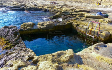 Pools carved into the stone shore on the island of Gozo, Malta
