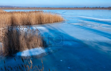 Photo for Frozen water, patterns of snow in small lakes. Tiligul estuary, Ukraine - Royalty Free Image