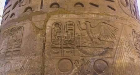 Photo for LUXOR, EGYPT - NOVEMBER 10, 2004: ancient Egyptian hieroglyphs, drawings and inscriptions on the walls and columns in the temple of Karnak in Luxor - Royalty Free Image