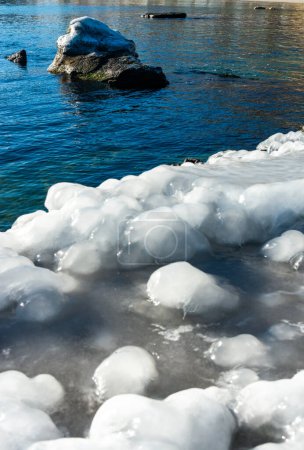 Glaçage d'une jetée en béton dans la mer Noire, blocs de glace fondue brillent au soleil, glace au bord de la mer, Odessa