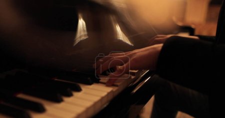 Male hands playing the piano. Professional piano playing close-up.