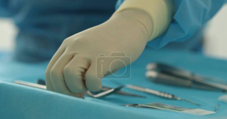 Photo for Doctor's hands with a working tool. Preparation and process of dental treatment. Dental instrument in the office of a modern dentist. Close-up in 4K, UHD - Royalty Free Image