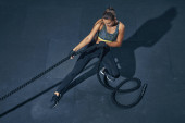 Power sporty female athlete exercising with rope at a gym top view. puzzle #665892850