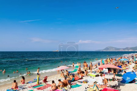 Photo for ISOLA D'ELBA, ITALY - August 25, 2018: day view of sea and bathers in famous Delle Ghiaie beach in Elba island, Tuscany, Italy. - Royalty Free Image