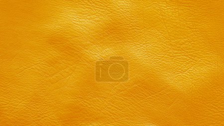 Téléchargez les photos : Texture froissée de cuir de vache jaune, gros plan. Fond cuir doré. - en image libre de droit