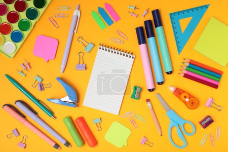 Photo for School and office supplies on yellow background, mock-up top view close-up - Royalty Free Image