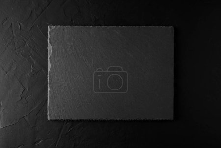 Photo for Black granite stone board on black concrete background. Background and Texture concept - Royalty Free Image