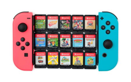 Photo for Nintendo games cartridges with joy-cons of Nintendo Switch console, isolated on white background. The Nintendo Switch is Nintendo seventh major home console platform, following the Wii U - Royalty Free Image