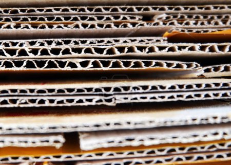 Photo for Stacked Cardboard Recycling Boxes In A Pile corrugated box close up stock photo copy space Paper cardboard, corrugated carton sheet background. Kraft cardboard texture with horizontal strip - Royalty Free Image