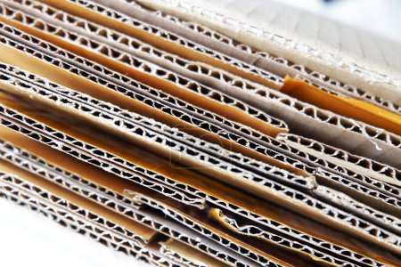 Photo for Stacked Cardboard Recycling Boxes In A Pile corrugated box close up stock photo copy space Paper cardboard, corrugated carton sheet background. Kraft cardboard texture with horizontal strip - Royalty Free Image