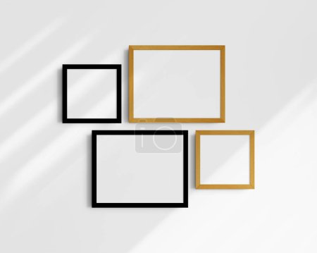 Foto de Conjunto de maquetas de pared Gallery, 4 marcos de roble negro y amarillo. Maqueta de marco limpia, moderna y minimalista. Dos marcos horizontales y dos cuadrados, 14x11 (14: 11), 8x8 (1: 1) pulgadas, en una pared blanca con sombras. - Imagen libre de derechos