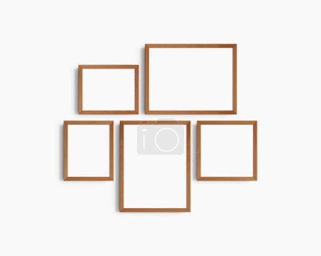 Photo for Gallery wall mockup set, 5 cherry wood frames. Clean, modern, and minimalist frame mockup. Two horizontal frames, two vertical frames, and a square frame, 12x16 (3:4), 16x12 (4:3), 8x10 (4:5), 10x8 (5:4), 10x10 (1:1) inches, on a white wall. - Royalty Free Image