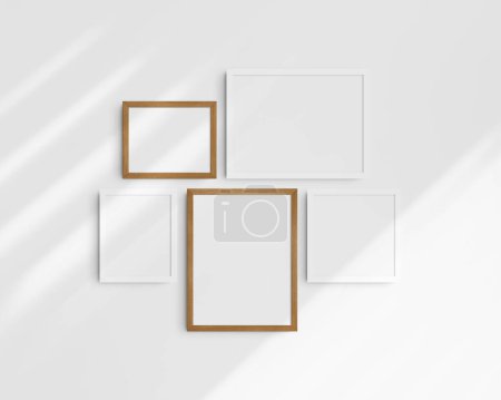 Photo for Gallery wall mockup set, 5 white and cherry wood frames. Modern frame mockup. Two horizontal frames, two vertical frames, and a square frame, 12x16 (3:4), 16x12 (4:3), 8x10 (4:5), 10x8 (5:4), 10x10 (1:1) inches, on a white wall with shadows. - Royalty Free Image