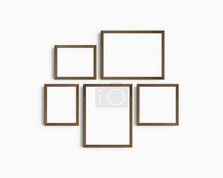 Photo for Gallery wall mockup set, 5 dark brown walnut wood frames. Modern, minimalist frame mockup. Two horizontal frames, two vertical frames, and a square frame, 12x16 (3:4), 16x12 (4:3), 8x10 (4:5), 10x8 (5:4), 10x10 (1:1) inches, on a white wall. - Royalty Free Image