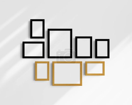 Foto de Conjunto de maquetas de pared Gallery, 8 marcos de madera de roble negro y amarillo. Una maqueta moderna y minimalista. Cinco marcos verticales, y tres horizontales, 4x6 (2: 3), 6x4 (3: 2), 5x7 (5: 7), 7x5 (7: 5), 8x10 (4: 5), 10x8 (5: 4) pulgadas, en una pared blanca con sombras. - Imagen libre de derechos