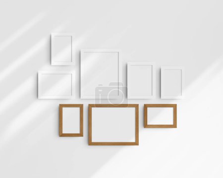 Photo for Gallery wall mockup set, 8 white and cherry wood frames. Modern, minimalist frame mockup. Five vertical frames, and three horizontal frames, 4x6 (2:3), 6x4 (3:2), 5x7 (5:7), 7x5 (7:5), 8x10 (4:5), 10x8 (5:4) inches, on a white wall with shadows. - Royalty Free Image