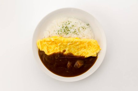 Japanese curry rice topped with Omelet in a white dish on white background.