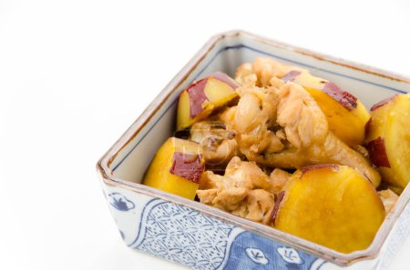 simmered sweet potato and chicken wings in deep square bowl