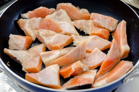 grilling trout salmon filet in a frying pan