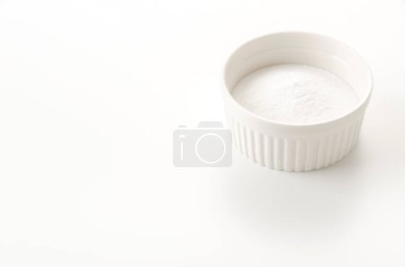 Baking soda in a cocotte on white background
