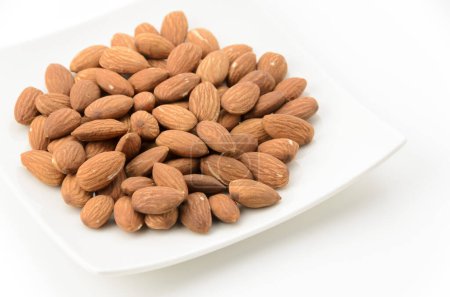 unglazed almonds on a white square plate on a white background