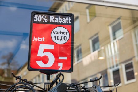 Eine Auslage mit 50% Rabatt steht draußen vor einem Modegeschäft in Deutschland.