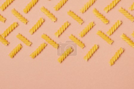 Pattern made of pasta on beige background. Close-up. Macro photo. Food concept. 