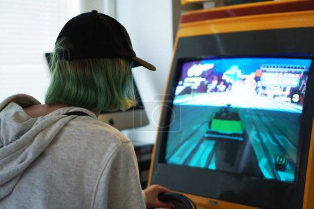Photo for Tallinn, Estonia - 21.05.2022: LVLup! Video Game Museum, Teenager playing game. - Royalty Free Image