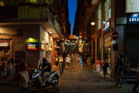 Photo for Naples, Italy - 11.06.2022: Crowdy night street in the old town. - Royalty Free Image