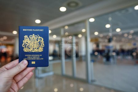 Man holding passport of United Kingdom.