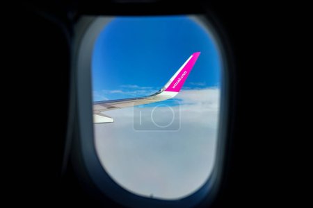 Photo for Naples, Italy - 24.06.2022: Wing of Wizz Air, view from window. - Royalty Free Image