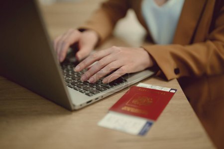 Photo for Woman with russian passport is waiting for her flight. - Royalty Free Image