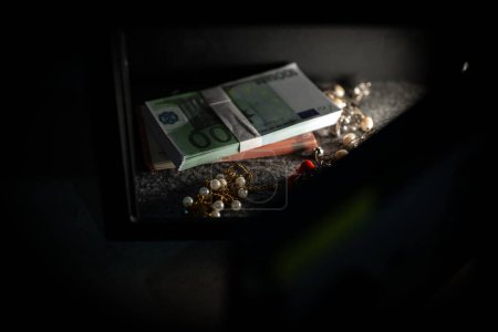 Foto de Caja fuerte de acero robado con billetes en euros y joyas. - Imagen libre de derechos
