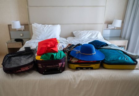 Photo for Suitcase with clothes on the bed. Preparing for vacation. - Royalty Free Image