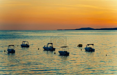 Many boats at sunset in the bay.